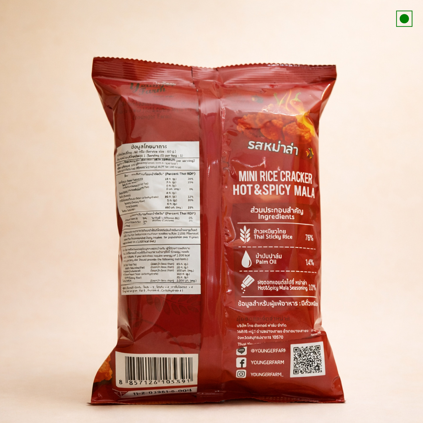 Red packaging of Younger Farms Mini Rice Cracker Hot & Spicy Mala on a beige background
