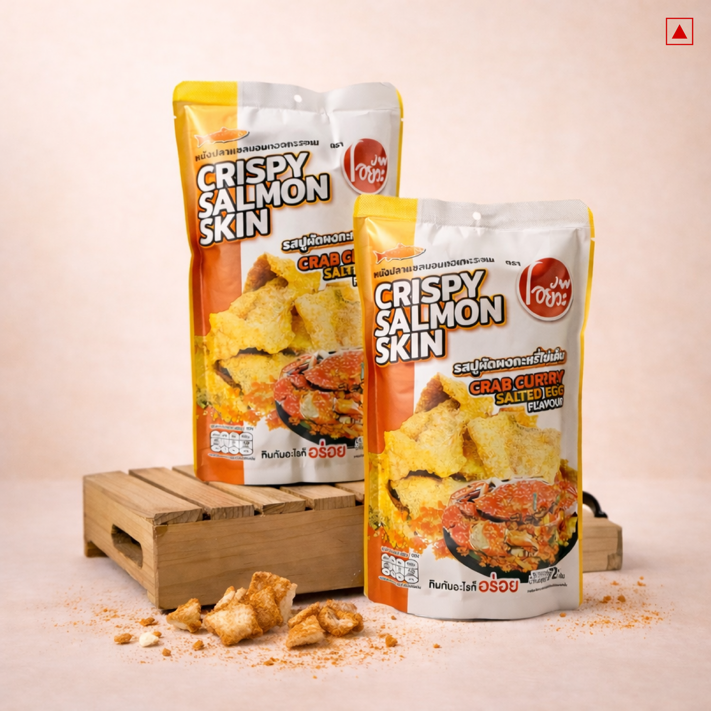 Two packages of Crispy Salmon Skin snacks on a wooden stand with a light background
