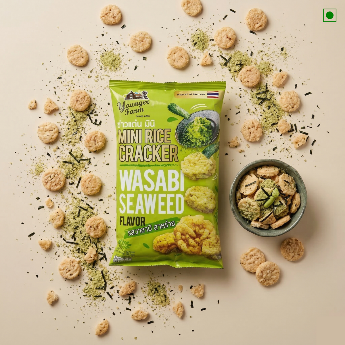 Green package of Wasabi Seaweed Mini Rice Crackers with crackers around on a beige background