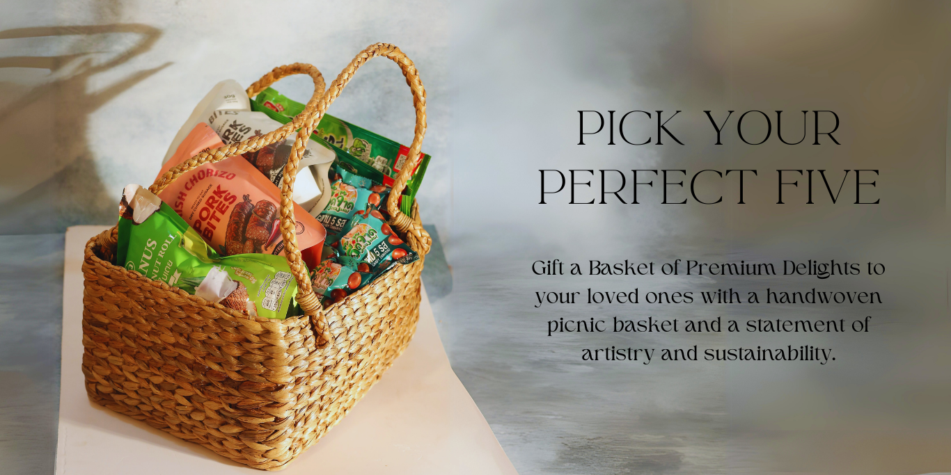 Woven basket with assorted items on a light surface, with text promoting a 'Perfect Five' gift option from PLB Snacks.