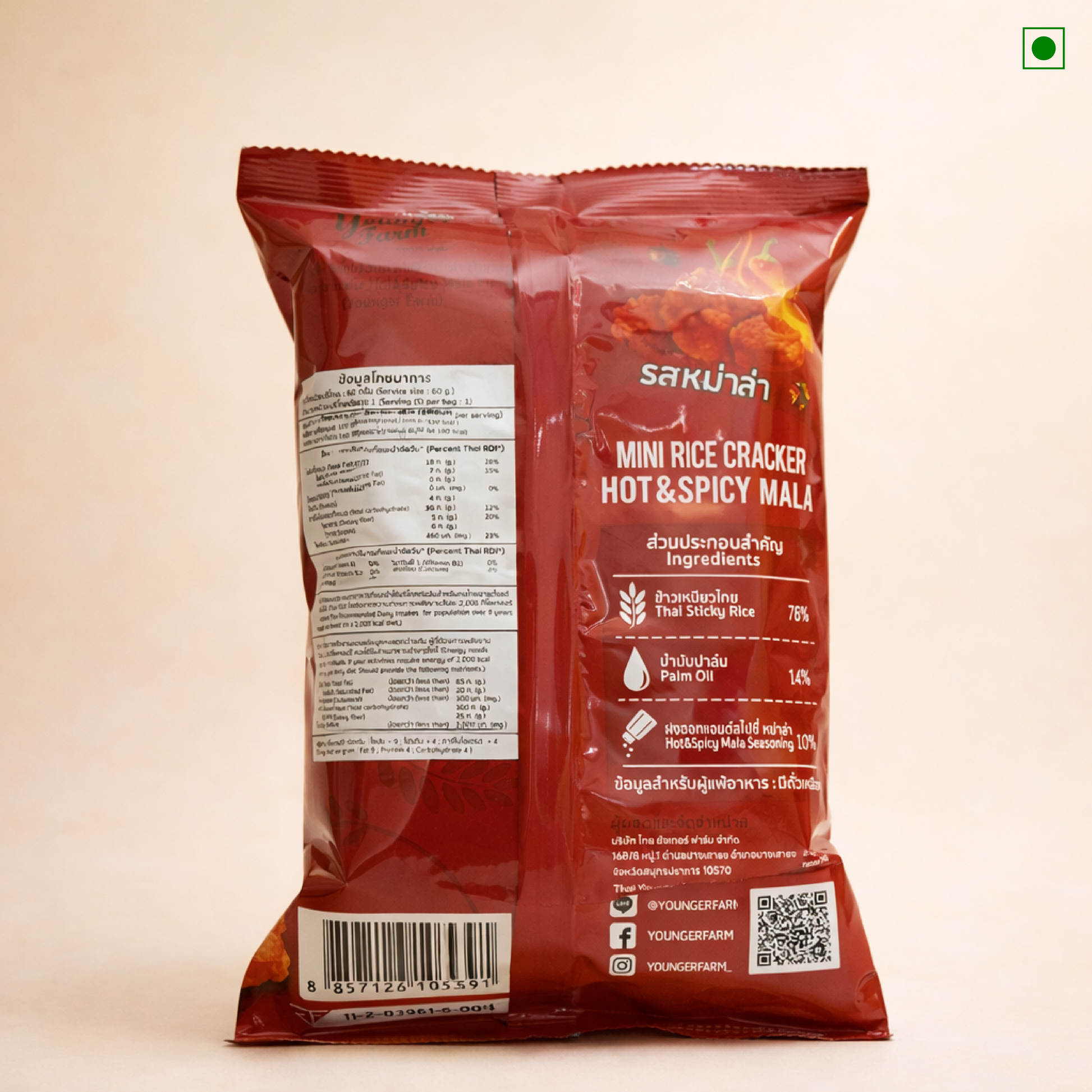 Red packaging of Younger Farms Mini Rice Cracker Hot & Spicy Mala on a beige background