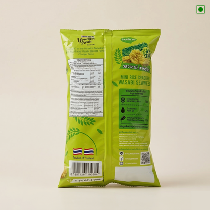 Green package of mini rice crackers with wasabi seaweed flavor on a beige background