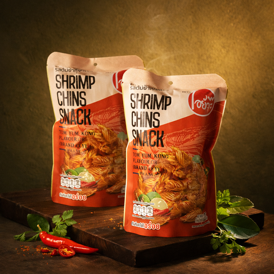 Two packages of Shrimp Chins Snack on a wooden surface with a warm background