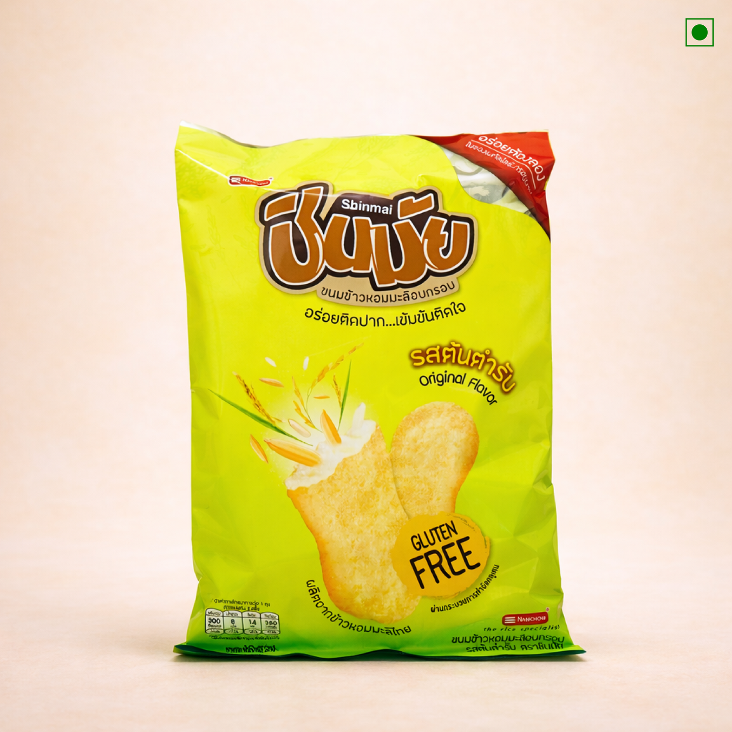 Green package of gluten-free Shinmai Japanese rice crackers with brand name on a beige background