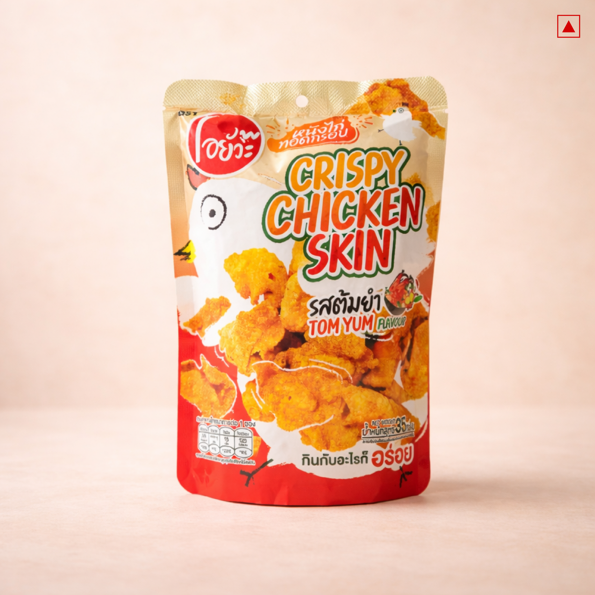 Packaging of crispy chicken skin snack with Tom Yum flavor on a beige background