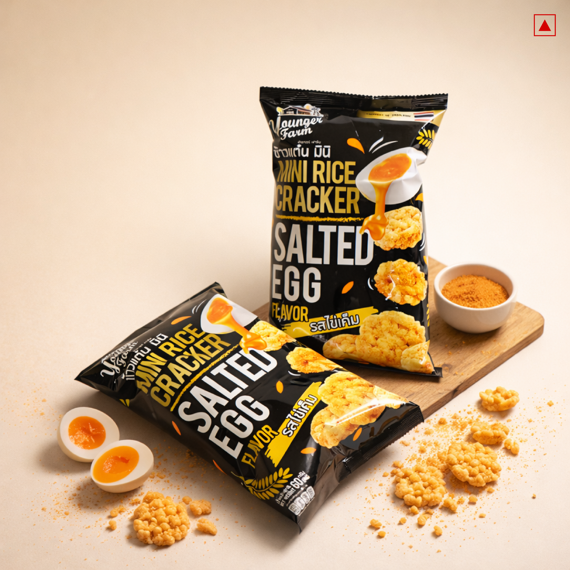 Two packages of salted egg flavor mini rice crackers on a wooden board with scattered crackers.