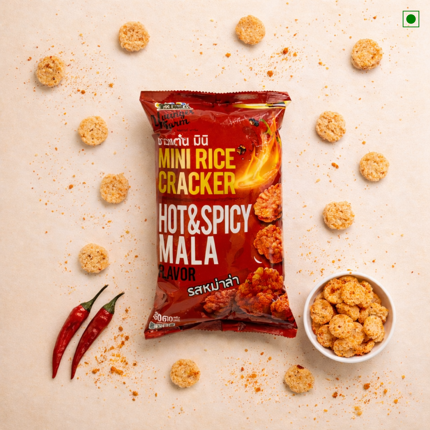 Packaged hot and spicy mala mini rice crackers with a bowl of crackers on a beige background.