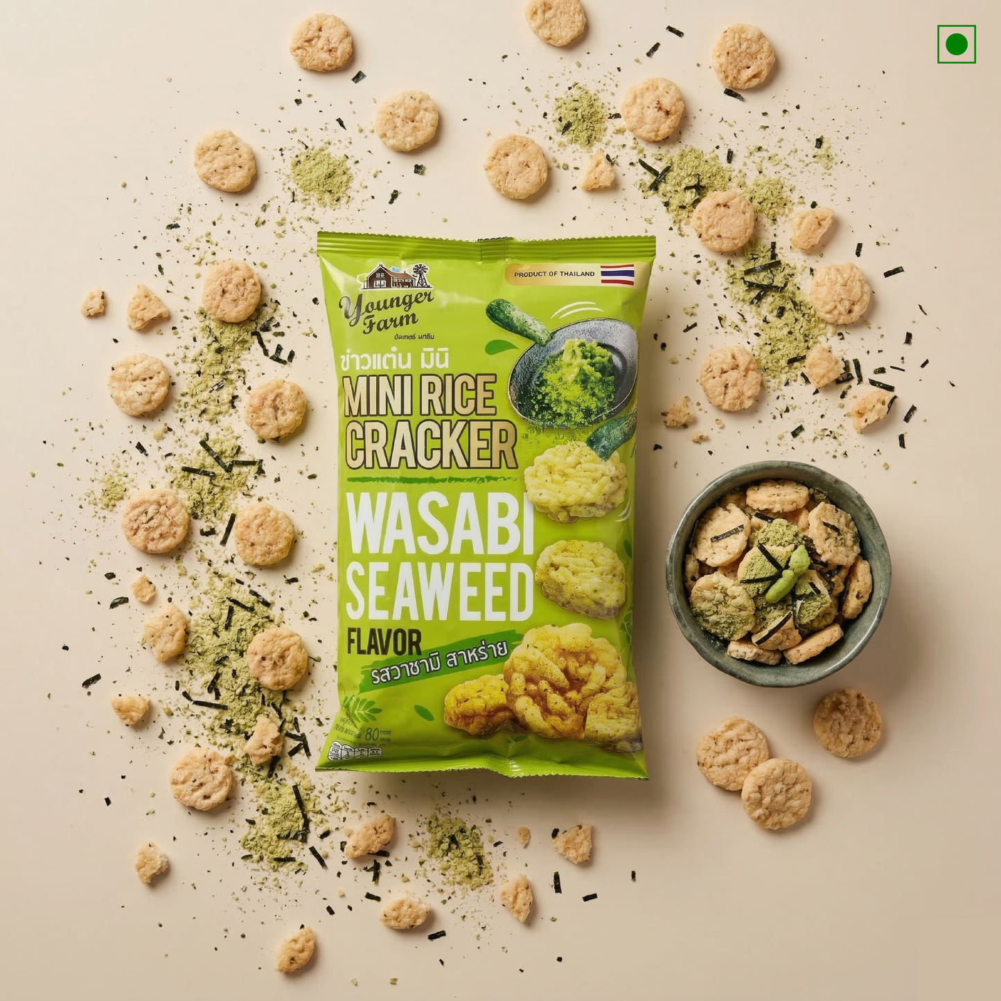 Green package of Wasabi Seaweed Mini Rice Crackers with crackers around on a beige background