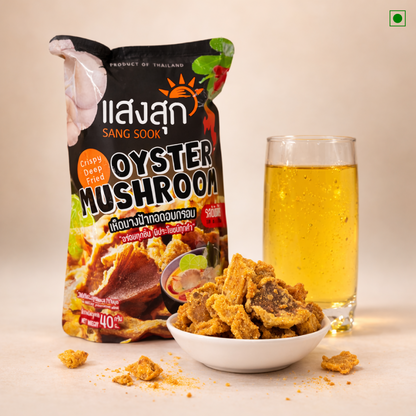 Oyster mushroom snack with a glass of beer and packaging on a light background