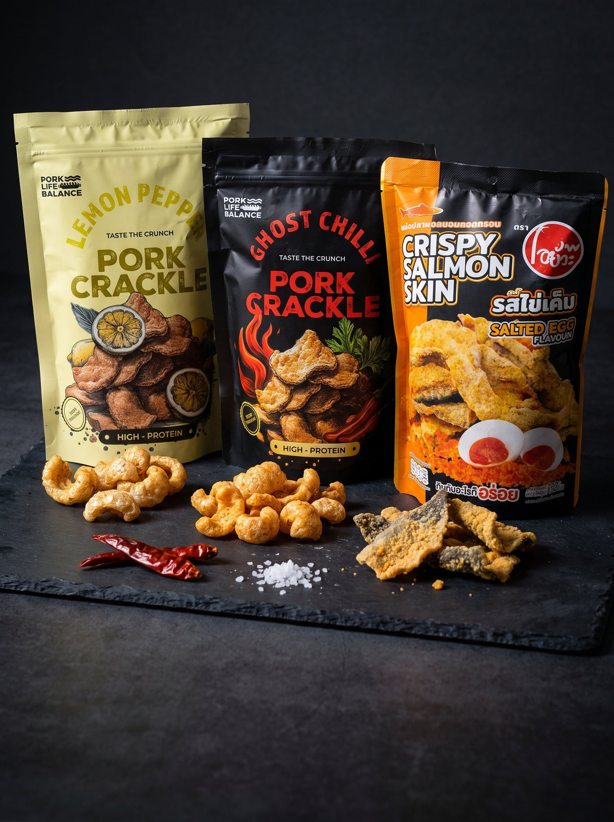 PLB Lemon Pepper and Ghost Chilli pork crackle with Thai crispy salmon skin on slate